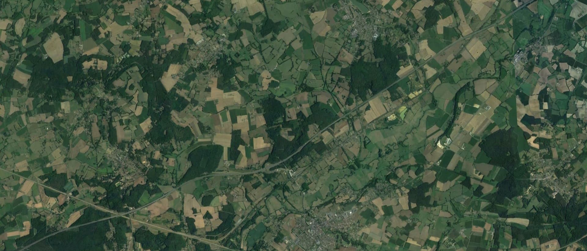 Overhead perspective of a verdant field, emphasizing the rich green hues and the natural beauty of the terrain